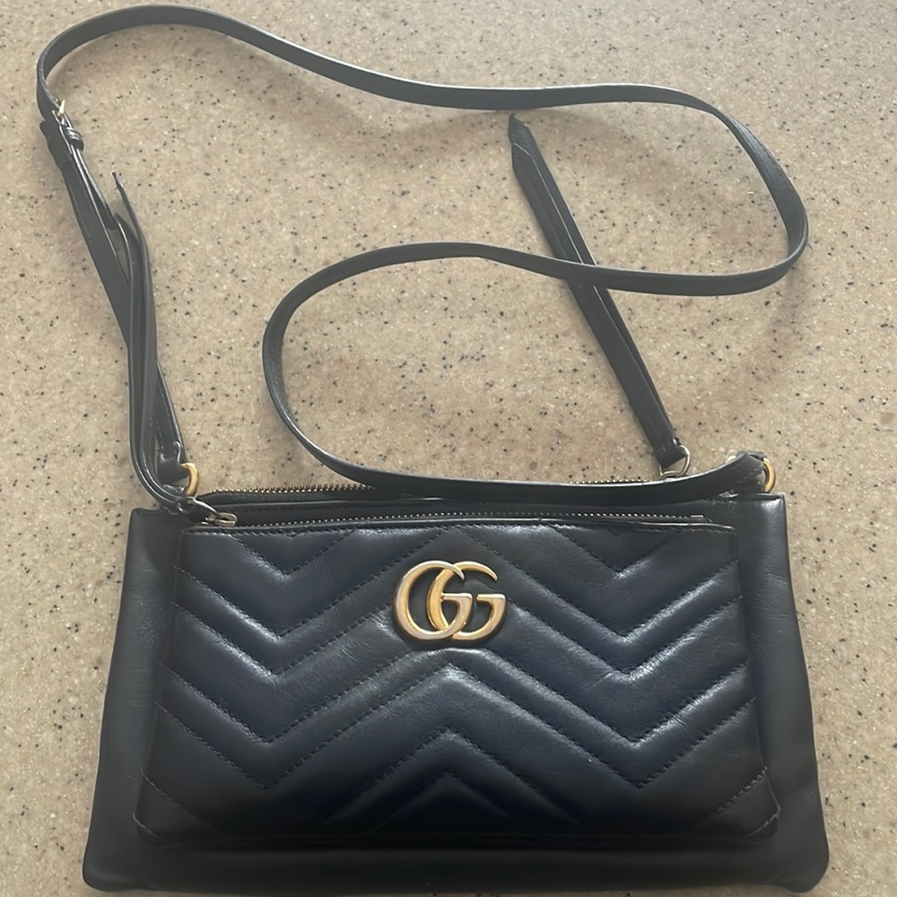 Black Quilted Leather Crossbody Bag with Gold Logo.